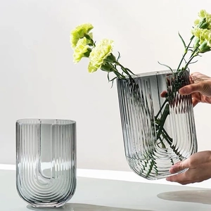 U-shaped ribbed glass flower vase in smoky gray with modern minimalist geometric design