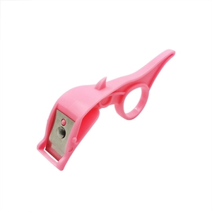 Pink plastic ring vegetable peeler with metal blade for fruits on white background