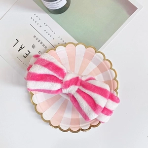 Detail of pink and white striped coral fleece headband with oversized plush bow