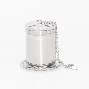 Detail of 304 stainless steel tea infuser with mesh basket, lid, chain, and base tray