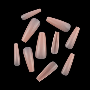 Detailed view of glossy pink press-on coffin nails in various sizes on a black background