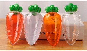 Close-up of carrot-shaped candy boxes with orange and white bodies and green leaf caps