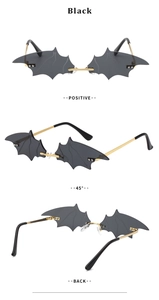 Three-view display of bat-shaped sunglasses with black lenses and gold metal frames
