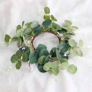 Nordic Easter decoration featuring a eucalyptus berry wreath on beige plush fabric