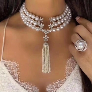 Elegant triple-strand pearl necklace set with crystal flower charm and matching ring