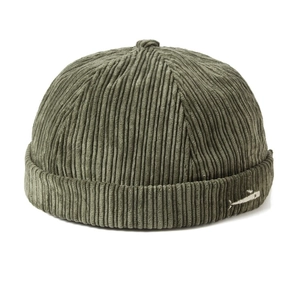 Detail of army green corduroy docker cap featuring a small white fish embroidery