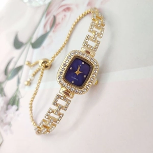 Detail of square crystal watch with blue dial and adjustable sliding bolo strap
