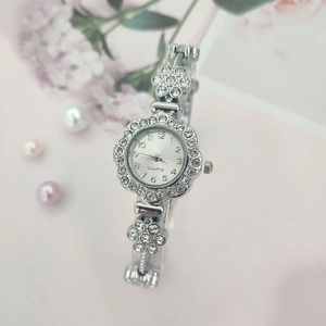 Elegant flower shaped quartz watch for women featuring sparkling rhinestones and silver metal