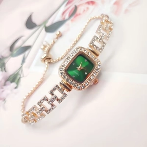 Detail of square green dial watch with crystal accents and adjustable sliding chain band