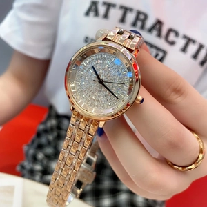Close-up of luxury rose gold watch featuring a diamond-encrusted dial and metal chain band
