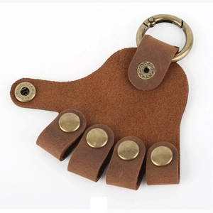 Brown leather hand-shaped keychain with bronze metal ring and finger loops for car keys