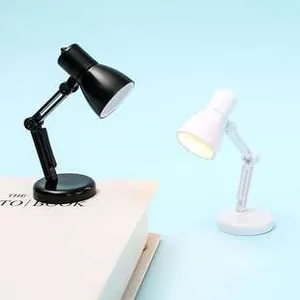 Miniature LED desk lamp keychain in black and white with adjustable folding arms