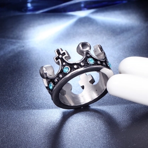 Macro shot of silver crown ring with blue gems and vintage steel texture details