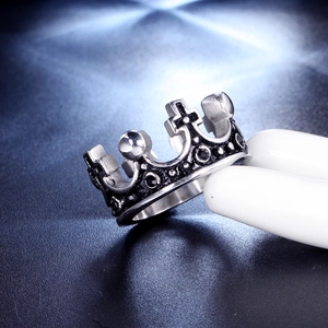 Macro view of a retro stainless steel crown ring with cross and sphere details