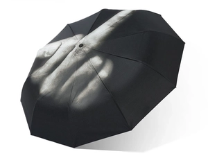 Macro detail of black folding umbrella featuring a bold novelty middle finger gesture print