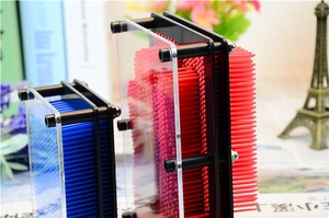 Detailed view of red and blue 3D pin art toys on a desk with a blurred background