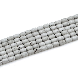 Macro shot of silver-gray cylindrical geode agate beads with natural mineral texture
