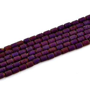 Macro detail of purple geode agate barrel beads with natural crystalline texture
