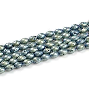 Macro view of blue-green metallic oval geode agate beads with natural stone texture