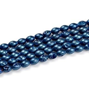 Macro view of metallic blue oval geode agate beads with porous lava texture for jewelry