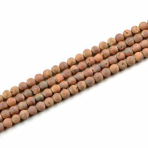 Macro shot of 10mm matte natural stone beads in earthy tones for DIY jewelry making