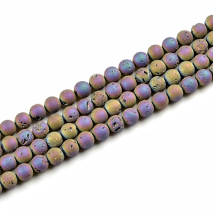 Macro shot of 10mm round purple gold lava stone beads with natural mineral texture