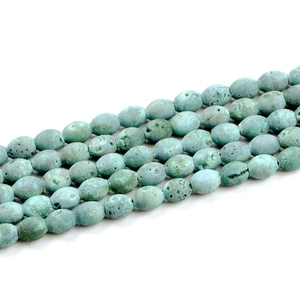 Close-up of light green natural geode agate drum beads for DIY jewelry making