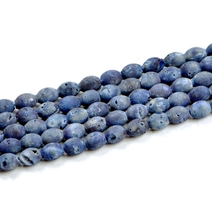 Macro shot of blue geode agate drum beads showing natural texture for handmade jewelry