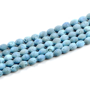 Macro shot of light blue druzy agate beads with natural porous texture for DIY jewelry
