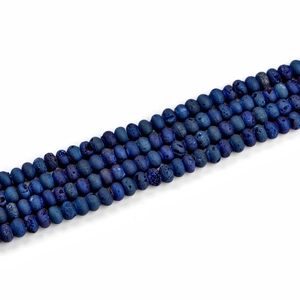 Macro detail of blue geode agate rondelle beads showing natural stone textures