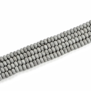 Macro detail of 5x8mm gray geode agate beads with raw texture and abacus shape