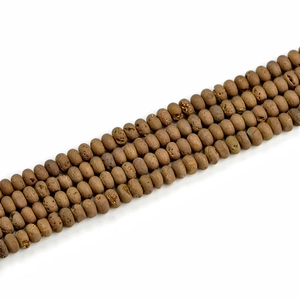 Detailed close-up of 5x8mm brown natural geode agate beads with raw earthy texture