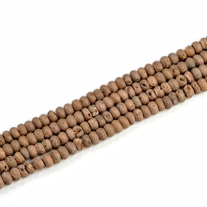 Detailed close-up of brown geode agate beads with natural rough texture for jewelry