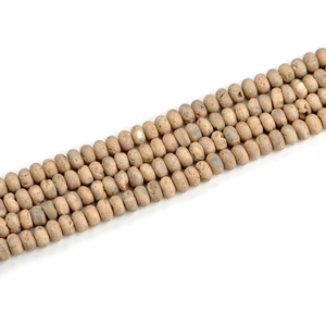 Macro detail of 5x8mm beige geode agate beads with natural matte texture for jewelry