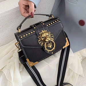Black litchi leather handbag with golden lion head clasp and striped shoulder strap