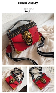 Detail of red and black studded shoulder bag with golden lion buckle and striped strap