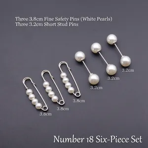Détail de six épingles de sûreté à perles en métal argenté pour ajuster les vêtements