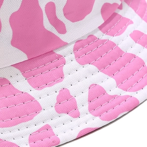 Pink and white cow print bucket hat in cotton twill with reinforced stitched brim
