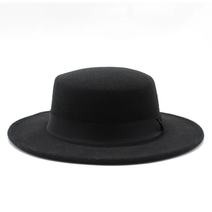 Detail of a vintage black flat top wool fedora with a matching satin ribbon band