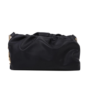 Detail of black pleated cloud bag in soft PU leather with elegant gold chain strap