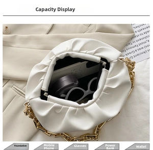 Internal capacity of white cloud bag showing phone, sunglasses and cosmetics