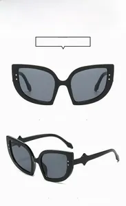 Detailed front and 45-degree side views of black cat-eye sunglasses with silver rivets
