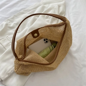 Chic woven straw shoulder bag with brown leather trim and magnetic closure for summer travel
