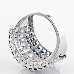 Macro detail of wide wedding ring with blue square stones and white cubic zirconia