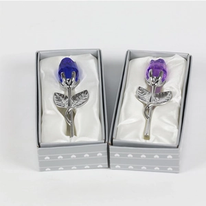 Macro detail of crystal roses in blue and purple colors inside a heart gift box