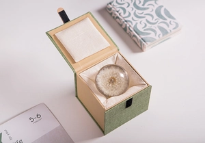 Dandelion crystal ball gift set inside a premium green linen box with elegant packaging
