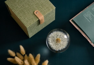 Detail of dandelion crystal ball in green luxury gift box with leather buckle decoration