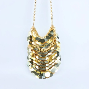 Close-up of golden metallic sequins on a stylish crossbody phone bag with chain links