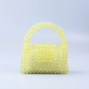 Handmade yellow beaded trapezoid handbag with a round handle in a minimalist style