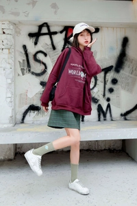 Close-up of green crew socks with star embroidery and white sneakers in a street style look